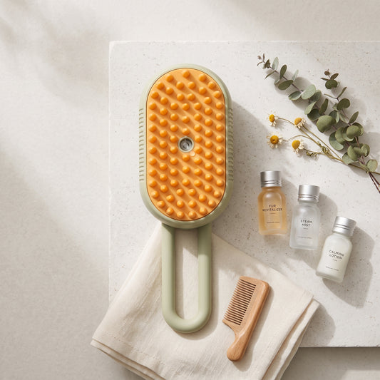 3-in-1 Electric Pet Grooming Brush displayed on a spa-style flat lay with eucalyptus, chamomile, a wooden comb and grooming mini bottles